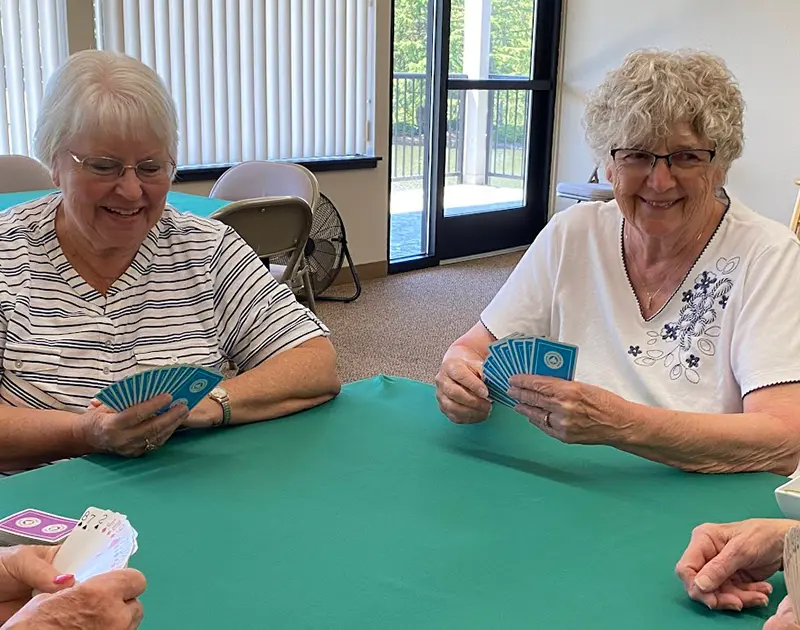 senior citizens playing card games at summerfield retirement community